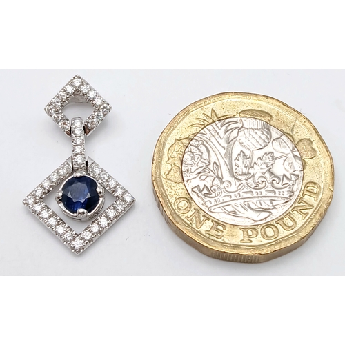 555 - AN 18K WHITE GOLD DIAMOND AND SAPPHIRE DROP PENDANT. 0.33CTW DIAMONDS AND 0.60CT SAPPHIRE. 2.5G.
22M... 