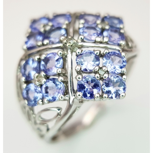558 - An Impressive 9 Carat White Gold Tanzanite and Diamond Set Ring, Size O. The Ring is set with sixtee... 