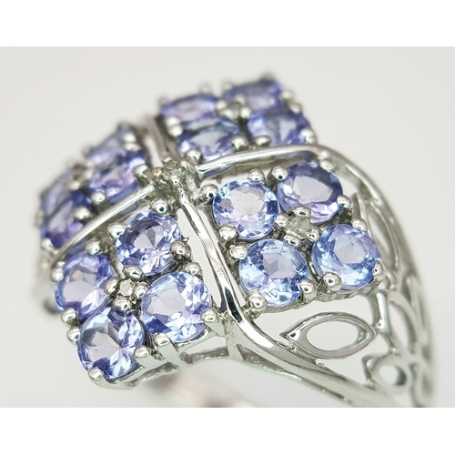 558 - An Impressive 9 Carat White Gold Tanzanite and Diamond Set Ring, Size O. The Ring is set with sixtee... 