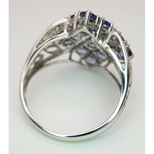 558 - An Impressive 9 Carat White Gold Tanzanite and Diamond Set Ring, Size O. The Ring is set with sixtee... 