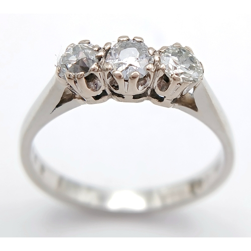569 - A PLATINUM DIAMOND 3 STONE RING. 0.70CTW. 3.5G. SIZE L. A/S -1313.