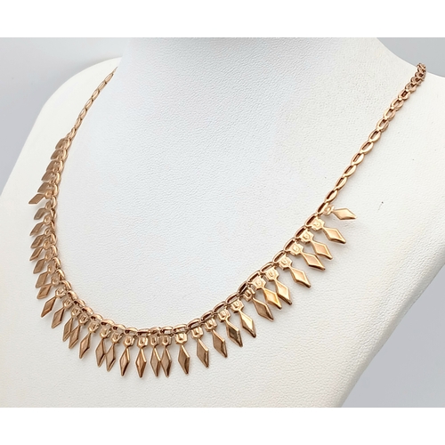 570 - A 9K Yellow Gold Diamond Head Form Necklace. 42cm. 6.9g. Note: Clasp in need of a new spring.