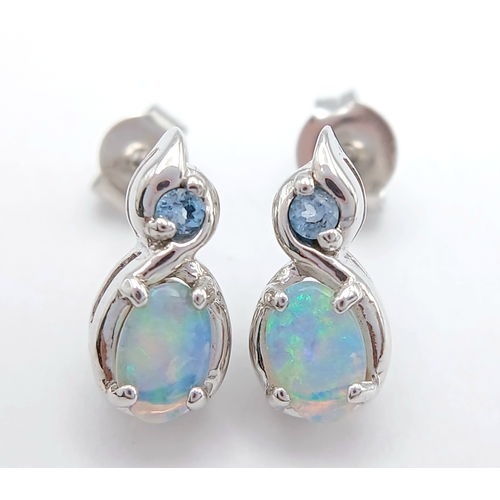 579 - A Stunning Pair of 9 Carat White Gold Opal and Blue Topaz Set Stud Earrings. 1.2cm Length. Gross Com... 