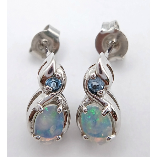 579 - A Stunning Pair of 9 Carat White Gold Opal and Blue Topaz Set Stud Earrings. 1.2cm Length. Gross Com... 