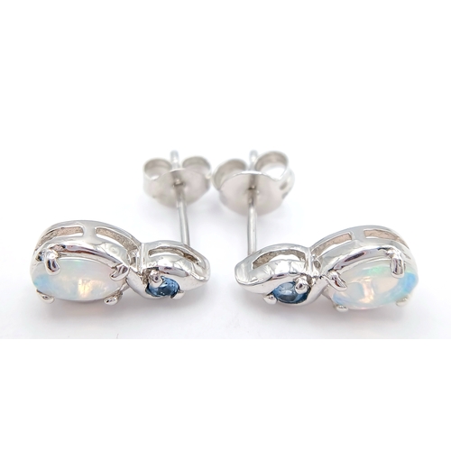 579 - A Stunning Pair of 9 Carat White Gold Opal and Blue Topaz Set Stud Earrings. 1.2cm Length. Gross Com... 