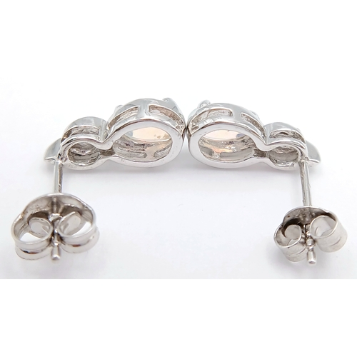 579 - A Stunning Pair of 9 Carat White Gold Opal and Blue Topaz Set Stud Earrings. 1.2cm Length. Gross Com... 