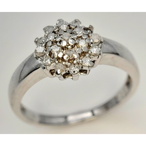 593 - A 9K WHITE GOLD DIAMOND CLUSTER RING. DIAMOND WEIGHT 0.25CT. TOTAL WEIGHT 2.2G. SIZE L 1/2. SC 9083