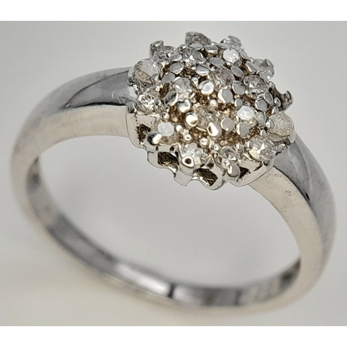 593 - A 9K WHITE GOLD DIAMOND CLUSTER RING. DIAMOND WEIGHT 0.25CT. TOTAL WEIGHT 2.2G. SIZE L 1/2. SC 9083