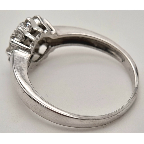 593 - A 9K WHITE GOLD DIAMOND CLUSTER RING. DIAMOND WEIGHT 0.25CT. TOTAL WEIGHT 2.2G. SIZE L 1/2. SC 9083