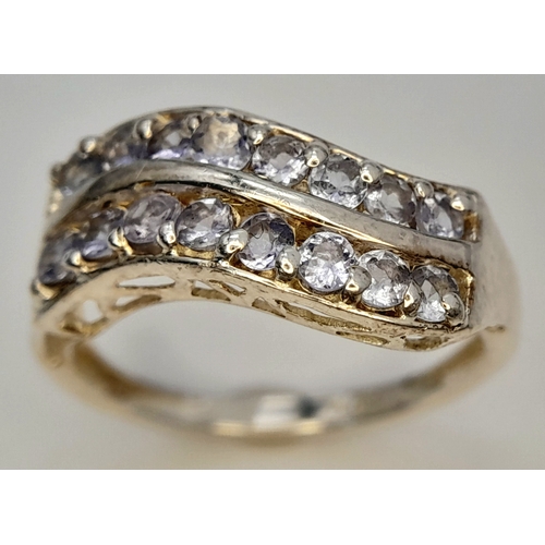 641 - A Sterling Silver Two Row Wave Style Tanzanite Ring, Size N1/2. The Ring is set with Sixteen 2mm Rou... 