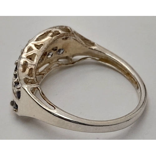 641 - A Sterling Silver Two Row Wave Style Tanzanite Ring, Size N1/2. The Ring is set with Sixteen 2mm Rou... 