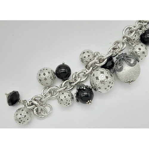 642 - A STERLING SILVER HEAVY CHARM BRACELET. 70.6G. 18CM.
JSIL-9011.