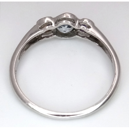648 - A Stylish Blue Topaz and Amethyst Trilogy Ring, Size S. The Ring is set with a 5mm Round Cut Blue To... 