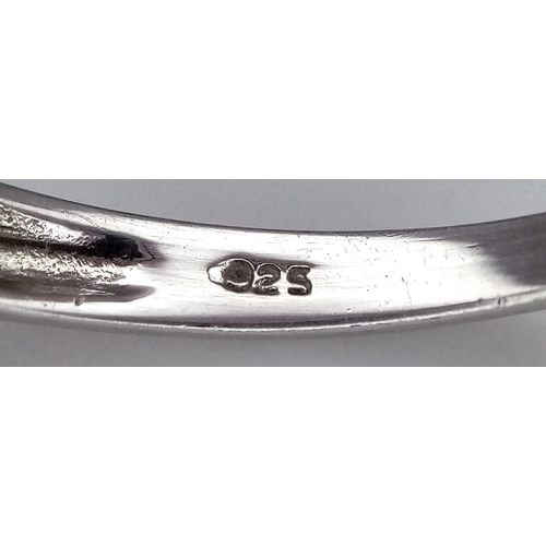 648 - A Stylish Blue Topaz and Amethyst Trilogy Ring, Size S. The Ring is set with a 5mm Round Cut Blue To... 