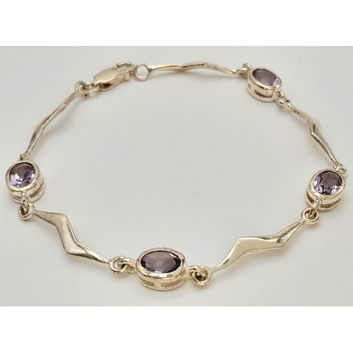 732 - A Pretty Sterling Silver Wave Design Amethyst Set Bracelet- 19cm Length. Set with Four 7mm Long Oval... 