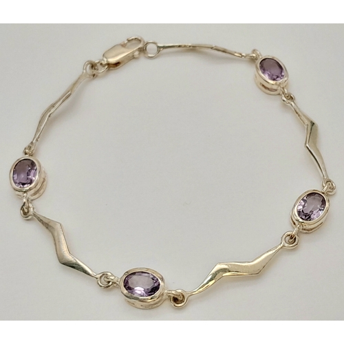 732 - A Pretty Sterling Silver Wave Design Amethyst Set Bracelet- 19cm Length. Set with Four 7mm Long Oval... 