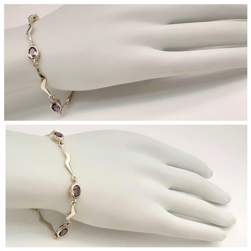 732 - A Pretty Sterling Silver Wave Design Amethyst Set Bracelet- 19cm Length. Set with Four 7mm Long Oval... 