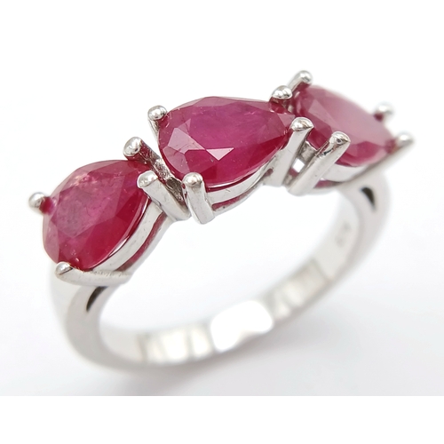 739 - A Sterling Silver Pear Cut Ruby Set Trilogy Ring, Size Q, The Ring is set with three 8mm Length Rubi... 