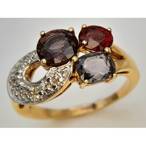 746 - An Impressive Gold on Sterling Silver, Garnet Amethyst, Tourmaline and Diamond Set Ring, Size S. The... 
