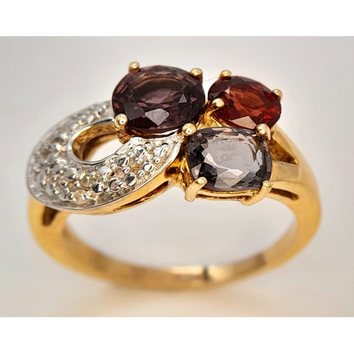 746 - An Impressive Gold on Sterling Silver, Garnet Amethyst, Tourmaline and Diamond Set Ring, Size S. The... 