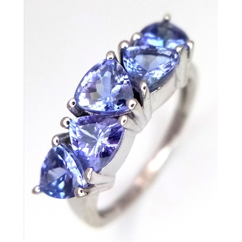 774 - A Sterling Silver and Trillion Cut Tanzanite Ring, Size O. The Ring is set with Five 5mm Long Trilli... 