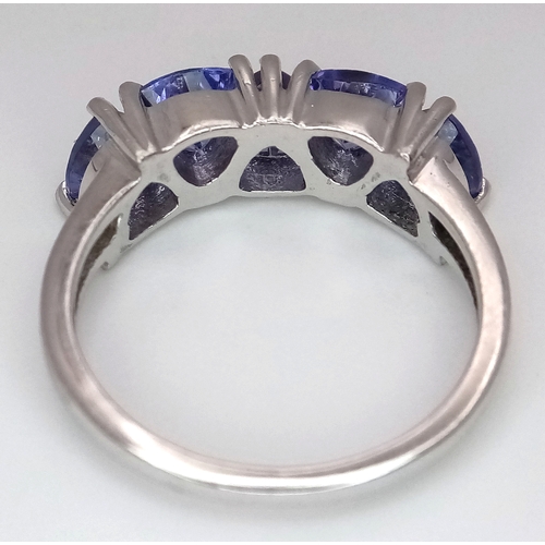 774 - A Sterling Silver and Trillion Cut Tanzanite Ring, Size O. The Ring is set with Five 5mm Long Trilli... 