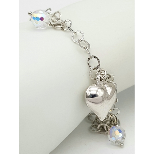 979 - A STERLING SILVER CRYSTAL AND HEARTS CHARM BRACELET. 9.6G. JSIL-9002