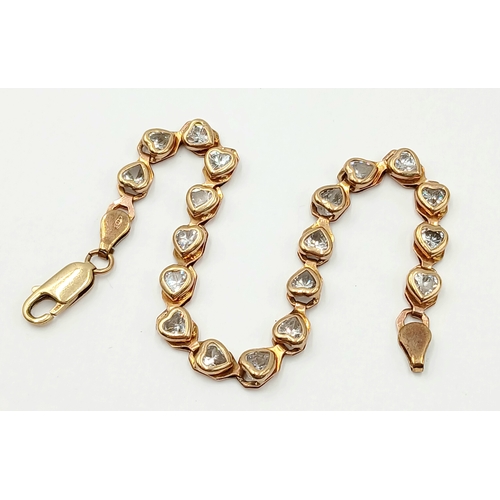 200 - A VERY PRETTY 9K GOLD BRACELET WITH HEARTS SHAPED CLEAR STONES .   9gms    20cms