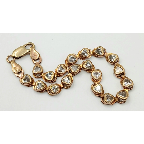200 - A VERY PRETTY 9K GOLD BRACELET WITH HEARTS SHAPED CLEAR STONES .   9gms    20cms