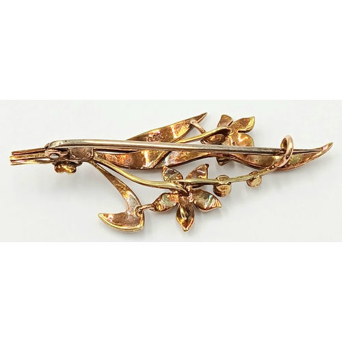 235 - AN ANTIQUE 15K GOLD BROOCH DECORATED WITH SEED PEARLS .      4.3gms