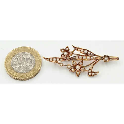 235 - AN ANTIQUE 15K GOLD BROOCH DECORATED WITH SEED PEARLS .      4.3gms
