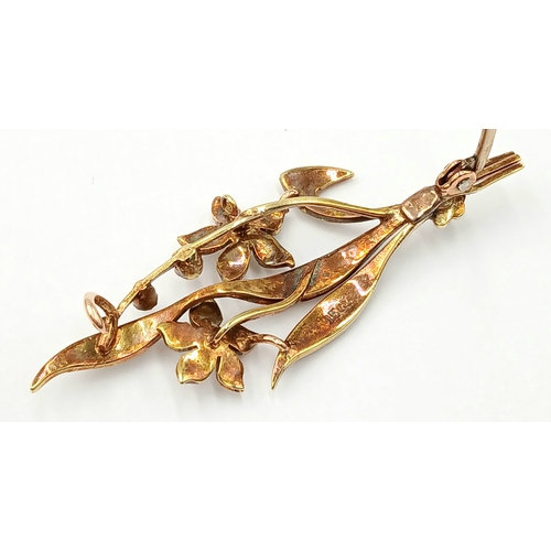 235 - AN ANTIQUE 15K GOLD BROOCH DECORATED WITH SEED PEARLS .      4.3gms
