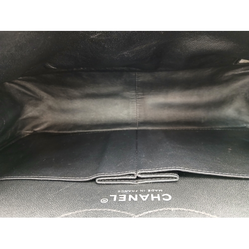 601 - A Chanel Black Patent Leather Classic Double Flap Bag.Black leather exterior with silver-toned hard... 