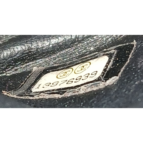 601 - A Chanel Black Patent Leather Classic Double Flap Bag.Black leather exterior with silver-toned hard... 