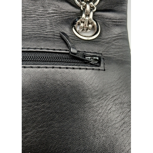 601 - A Chanel Black Patent Leather Classic Double Flap Bag.Black leather exterior with silver-toned hard... 