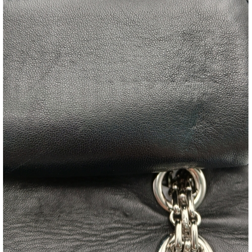 601 - A Chanel Black Patent Leather Classic Double Flap Bag.Black leather exterior with silver-toned hard... 