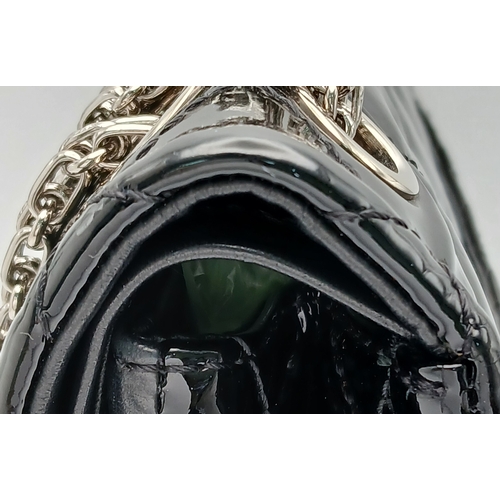 601 - A Chanel Black Patent Leather Classic Double Flap Bag.Black leather exterior with silver-toned hard... 