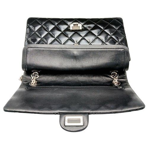 601 - A Chanel Black Patent Leather Classic Double Flap Bag.Black leather exterior with silver-toned hard... 