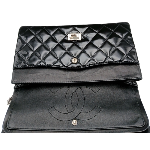 601 - A Chanel Black Patent Leather Classic Double Flap Bag.Black leather exterior with silver-toned hard... 