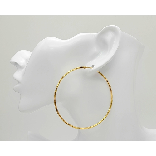 165 - A PAIR OF LARGE HOOP EARRINGS IN 18K GOLD .   6.8gms