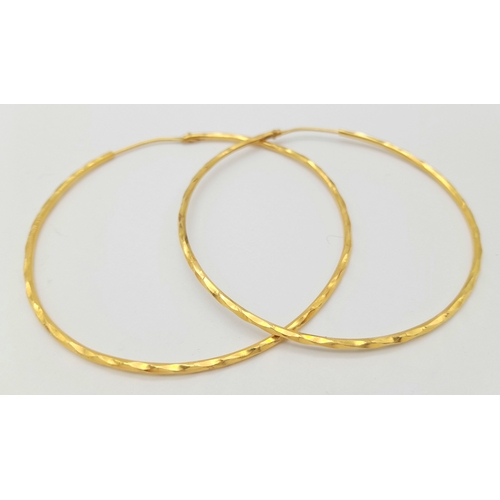 165 - A PAIR OF LARGE HOOP EARRINGS IN 18K GOLD .   6.8gms