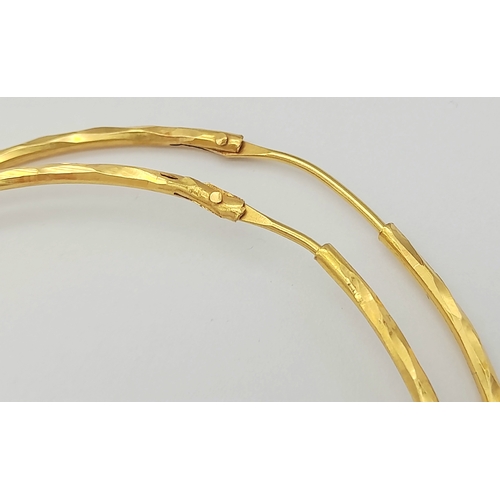 165 - A PAIR OF LARGE HOOP EARRINGS IN 18K GOLD .   6.8gms