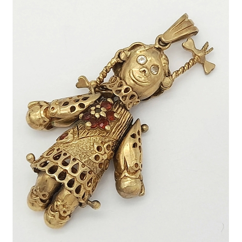 591 - A 9K GOLD PENDANT IN THE FORM OF AN ARTICULATED PIG TAILED GIRL WITH DIAMOND EYES.    5.8gms     4cm... 