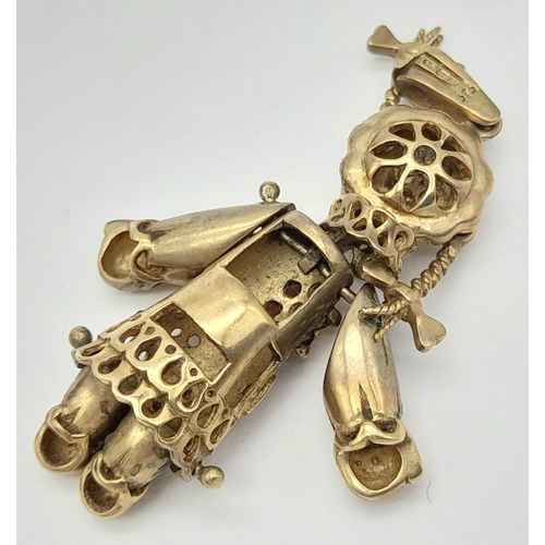 591 - A 9K GOLD PENDANT IN THE FORM OF AN ARTICULATED PIG TAILED GIRL WITH DIAMOND EYES.    5.8gms     4cm... 