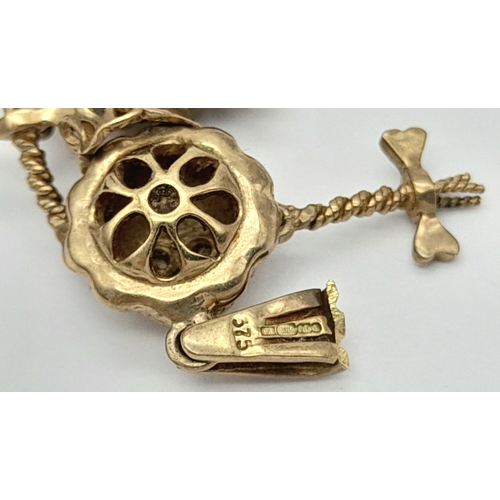 591 - A 9K GOLD PENDANT IN THE FORM OF AN ARTICULATED PIG TAILED GIRL WITH DIAMOND EYES.    5.8gms     4cm... 