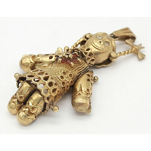 591 - A 9K GOLD PENDANT IN THE FORM OF AN ARTICULATED PIG TAILED GIRL WITH DIAMOND EYES.    5.8gms     4cm... 