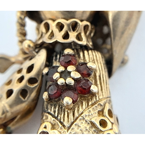 591 - A 9K GOLD PENDANT IN THE FORM OF AN ARTICULATED PIG TAILED GIRL WITH DIAMOND EYES.    5.8gms     4cm... 