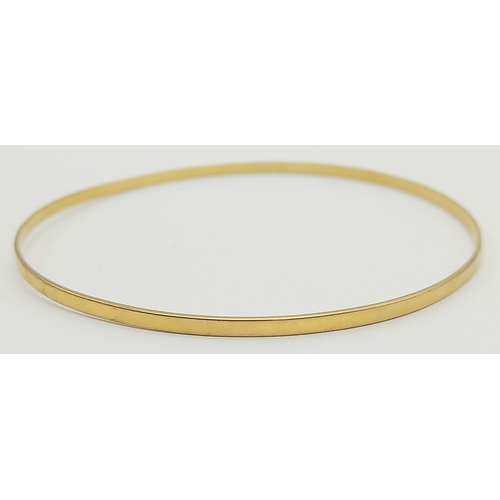 597 - A 9K GOLD SLIMLINE BANGLE .      4.1gms