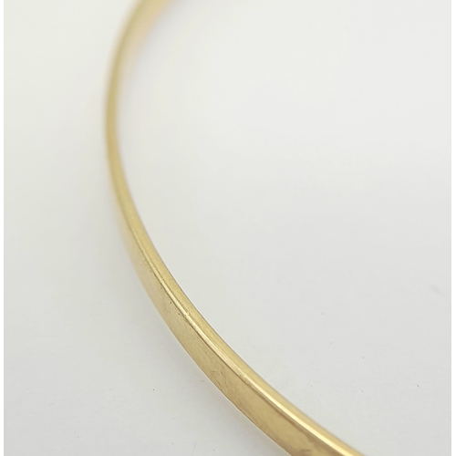 597 - A 9K GOLD SLIMLINE BANGLE .      4.1gms