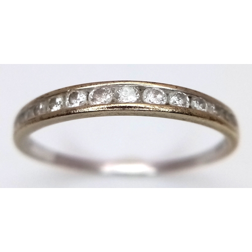 604 - A 9K White Gold Diamond Half Eternity Ring. Size O 1/2. 1.1g.